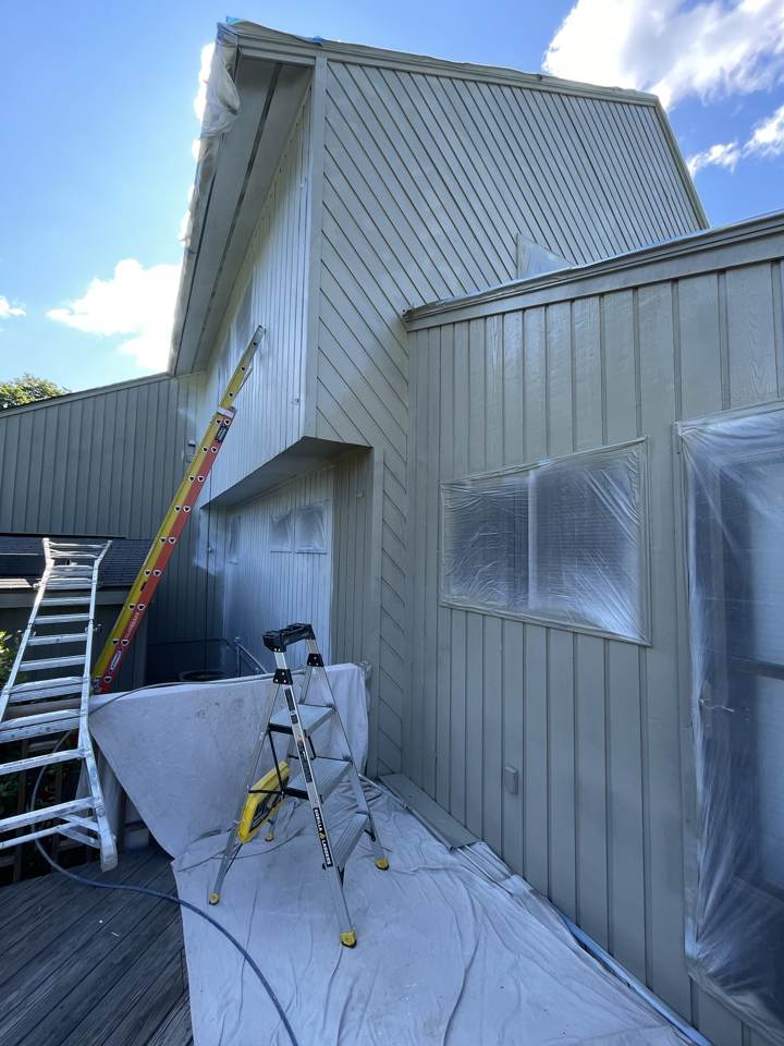 Exterior siding masked and prepped for painting