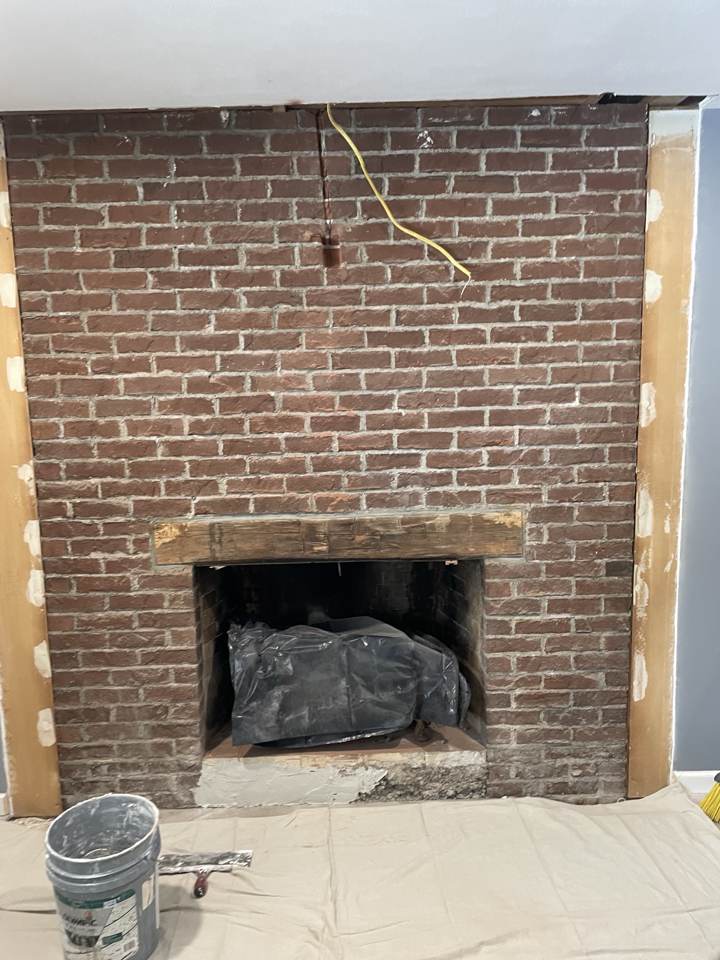 Brick fireplace being prepped for a remodel