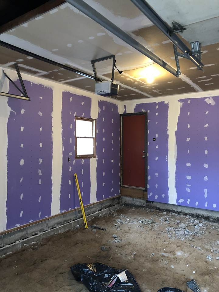 Drywall hung and taped in a garage conversion room