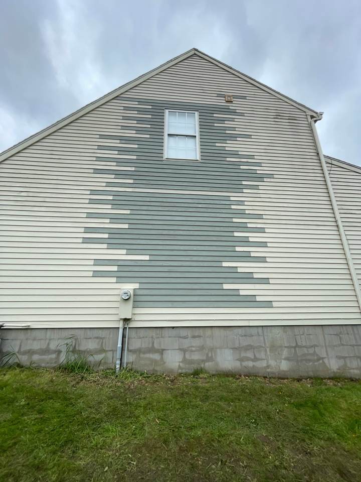 Vinyl siding with a section of boards being replaced